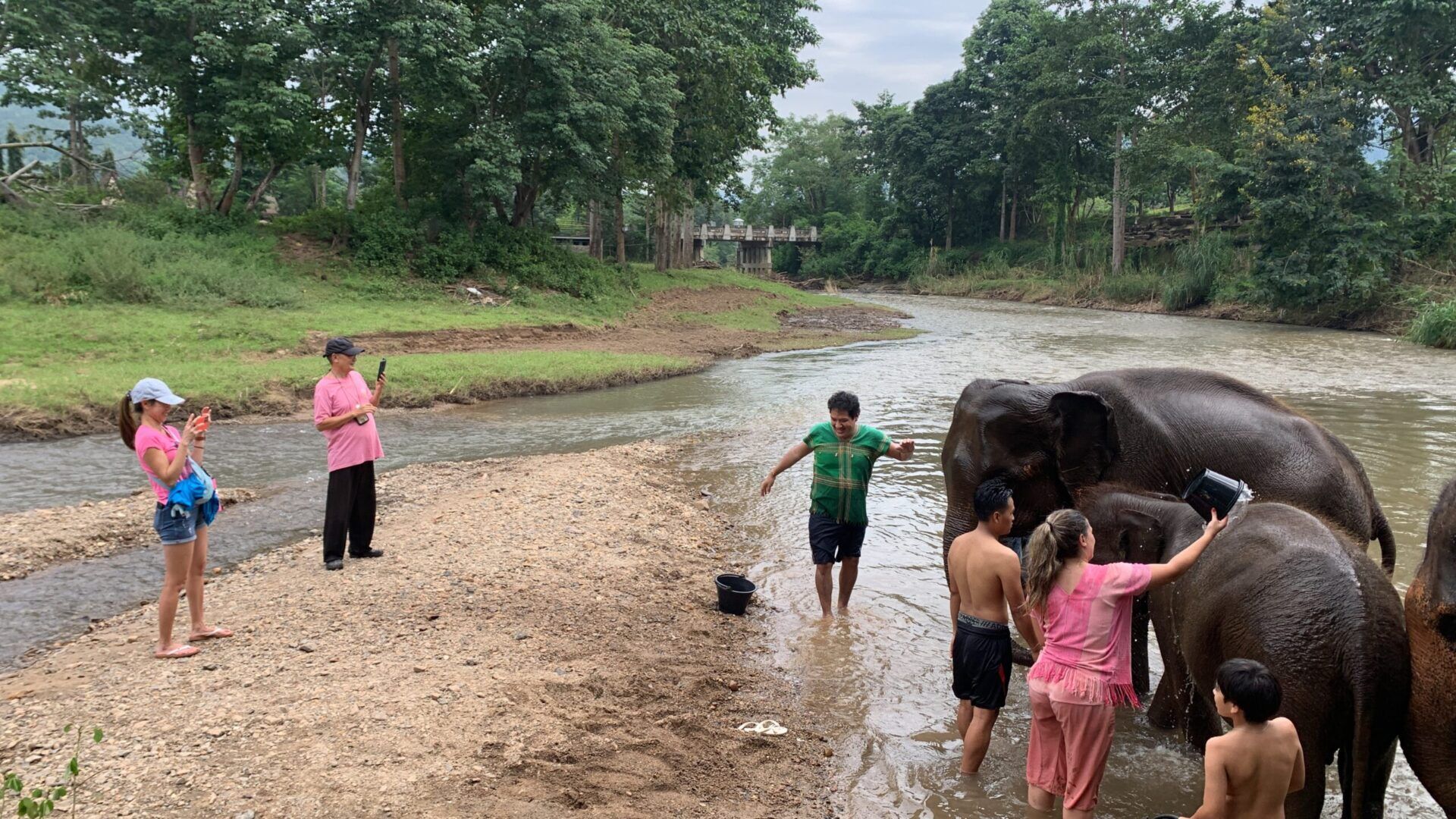 An elephant and a group of people standing in a river.