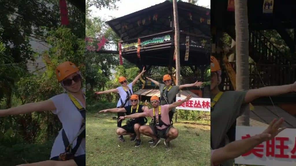 A group of people wearing safety gear while ziplining in Chiang Mai.