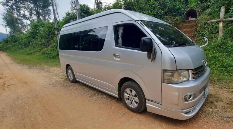 Transportation: A silver van is parked on a dirt road.