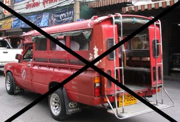 A red truck with a stop sign charges in front of it.